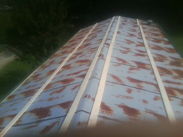 Rusted metal roof panels with new wood purlins before replacement — Storm Damage Roof Repair in Pegram by Roofing Brothers